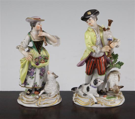 A pair of Meissen groups of a musical shepherd and shepherdess, 20th century, 16cm. and 15cm., minor losses to leaves